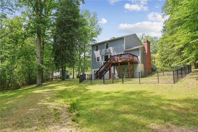 rear view of property featuring a chimney, a yard, fence, a deck, and stairway