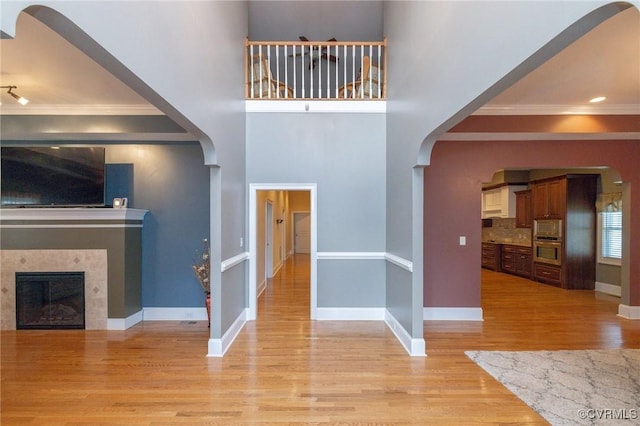 405 Church St, Blackstone, VA 23824 - entrance foyer featuring a tile fireplace, crown molding, light wood-style floors, and baseboards