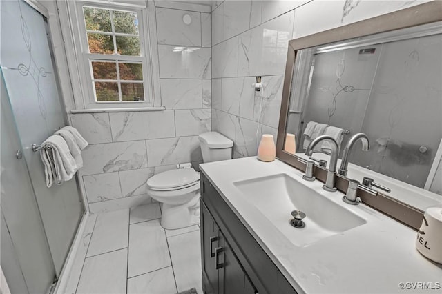 2704 Greenway Ave, Henrico, VA 23228 - full bathroom featuring vanity, toilet, marble look tiles, tile walls, and a shower with door