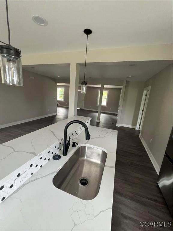 1506 Old Poole Rd, Alberta, VA 23821 - kitchen with light stone counters, baseboards, open floor plan, and a sink