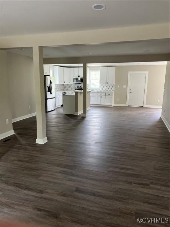 1506 Old Poole Rd, Alberta, VA 23821 - unfurnished living room featuring dark wood-type flooring, baseboards, and visible vents