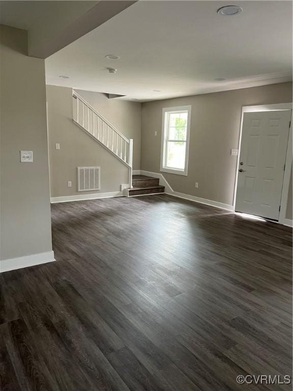 1506 Old Poole Rd, Alberta, VA 23821 - unfurnished living room featuring baseboards, dark wood finished floors, visible vents, crown molding, and stairway