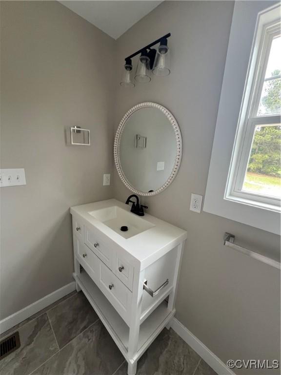 1506 Old Poole Rd, Alberta, VA 23821 - bathroom with vanity, baseboards, and visible vents