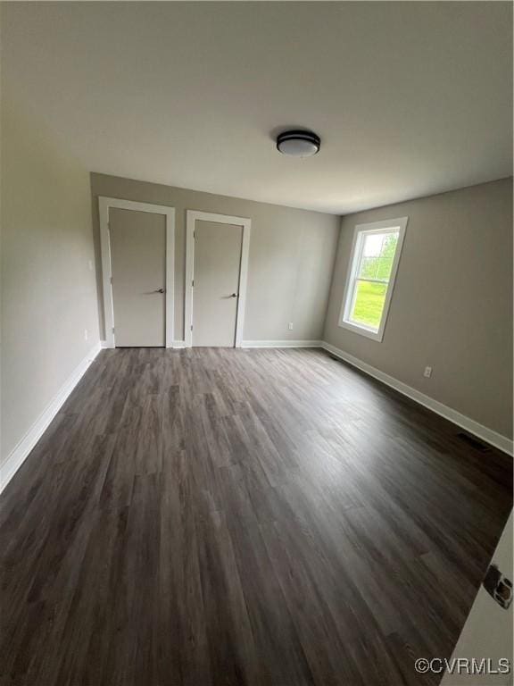 1506 Old Poole Rd, Alberta, VA 23821 - unfurnished bedroom featuring dark wood-type flooring and baseboards