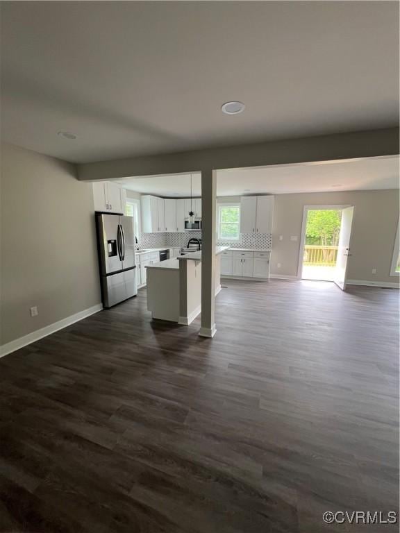 1506 Old Poole Rd, Alberta, VA 23821 - kitchen with white cabinetry, open floor plan, appliances with stainless steel finishes, and tasteful backsplash
