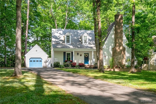 cape cod home featuring an outbuilding, a detached garage, a front yard, driveway, and covered porch