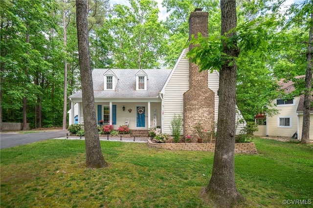 cape cod home with a chimney, a front yard, a porch, and a shingled roof