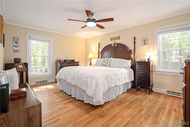 bedroom featuring multiple windows, light wood-style flooring, baseboards, ornamental molding, and a ceiling fan