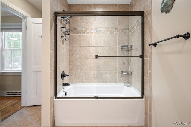 full bath featuring combined bath / shower with glass door and tile patterned floors