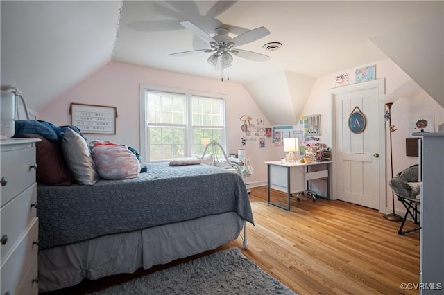 bedroom with vaulted ceiling, light wood-style flooring, and a ceiling fan