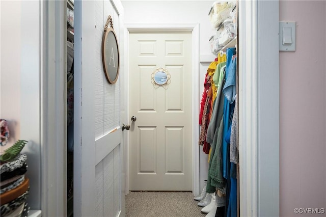 doorway to outside with carpet flooring