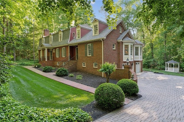 2410 Walhala Dr, North Chesterfield, VA 23236 - view of side of home featuring brick siding, driveway, a gazebo, a lawn, and an attached garage