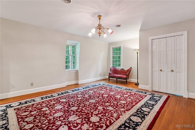 2410 Walhala Dr, North Chesterfield, VA 23236 - sitting room with a chandelier, light wood-style floors, and baseboards
