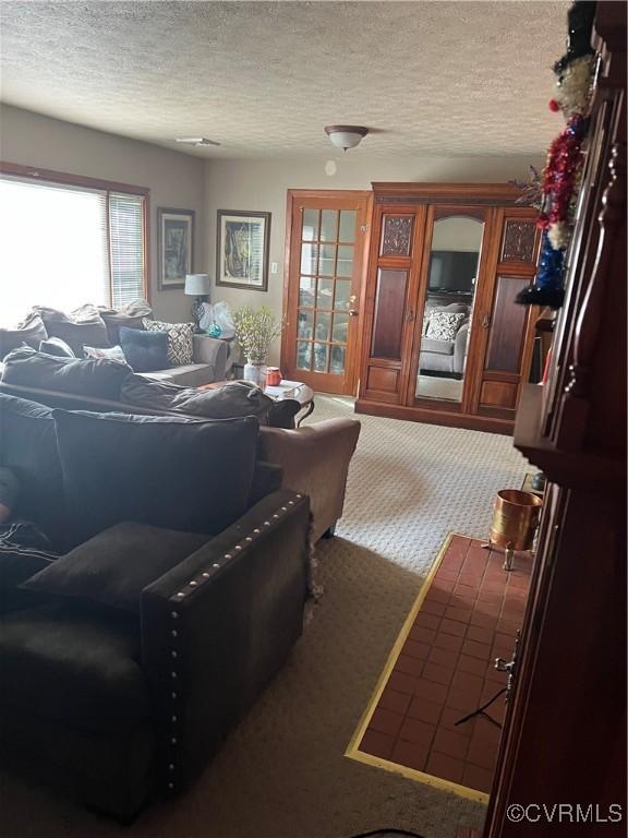 carpeted living room featuring a textured ceiling