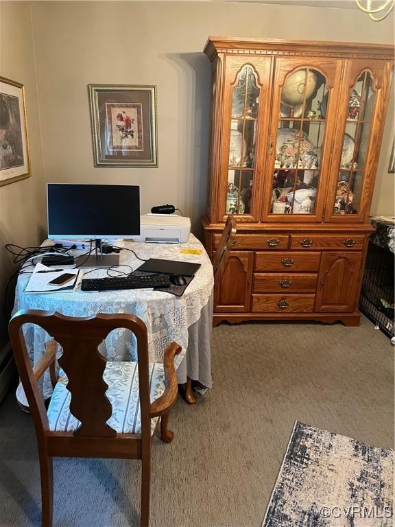 dining area featuring carpet flooring and an office area