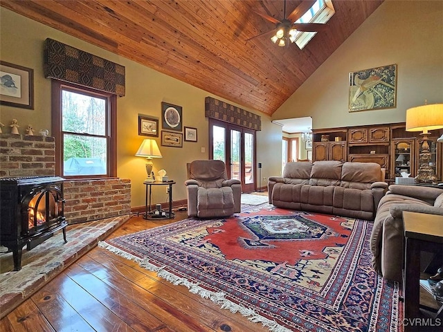 12448 Whisana Ln, Ashland, VA 23005 - living area with a wood stove, ceiling fan, healthy amount of natural light, wood-type flooring, and high vaulted ceiling