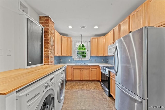 kitchen with stainless steel appliances, a sink, light brown cabinetry, and recessed lighting