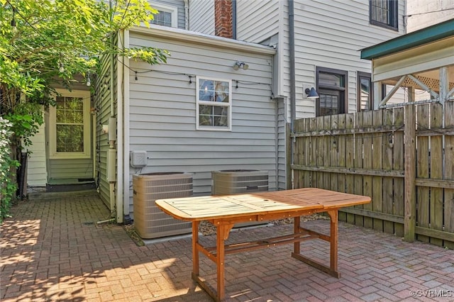 view of patio / terrace featuring central AC unit and fence