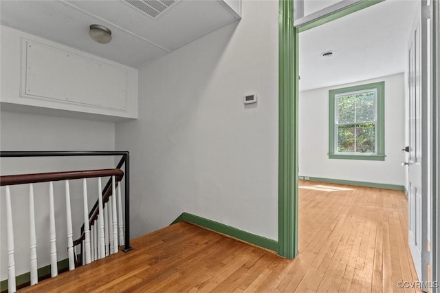 stairs with hardwood / wood-style floors and baseboards