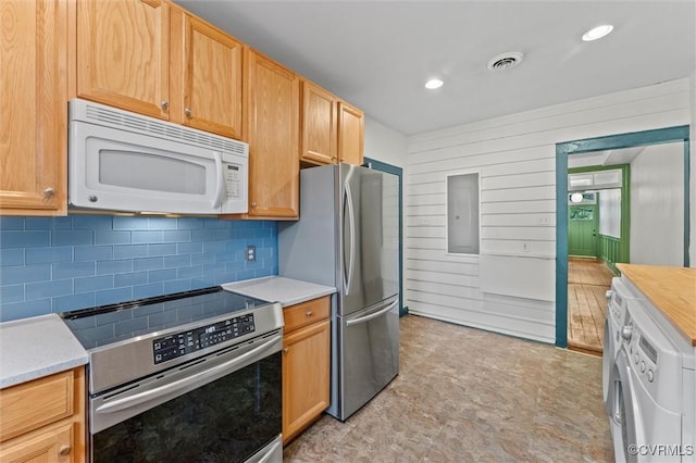 kitchen with stainless steel appliances, washer / dryer, decorative backsplash, light countertops, and recessed lighting