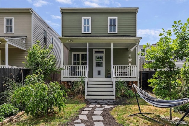view of front facade with a porch and fence