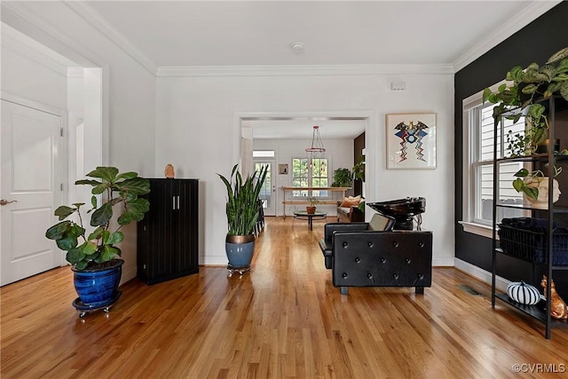 entryway featuring wood finished floors and crown molding