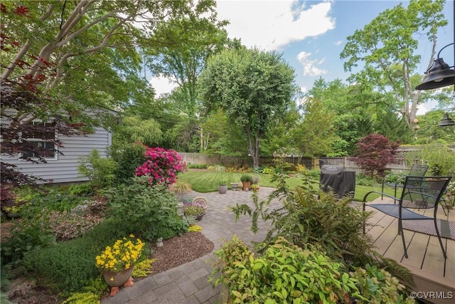 fenced backyard featuring a deck