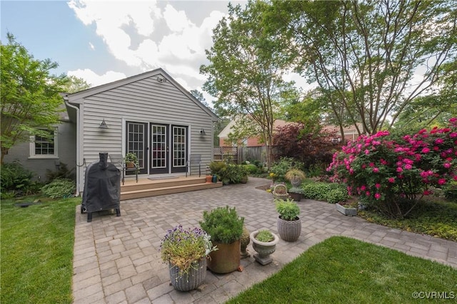 rear view of property featuring a patio area and a wooden deck