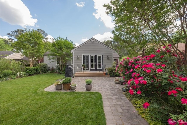 back of house featuring a patio area and a yard