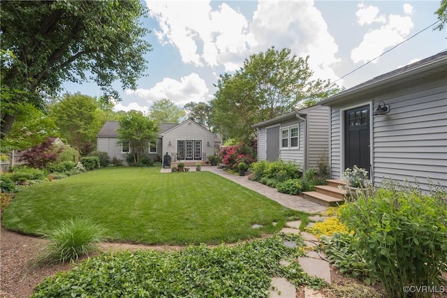 view of grassy yard with entry steps
