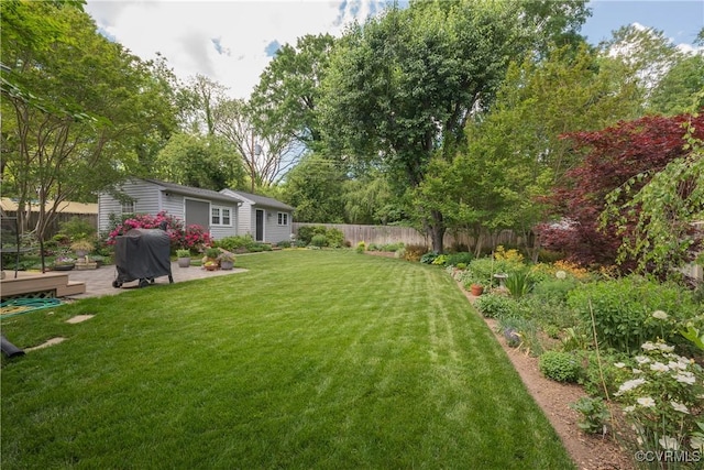 view of yard with a patio area and an outbuilding