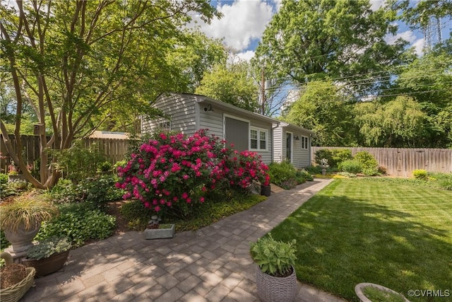 view of yard with an outbuilding and a patio area