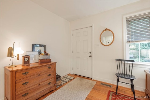 foyer entrance featuring light wood-style flooring and baseboards