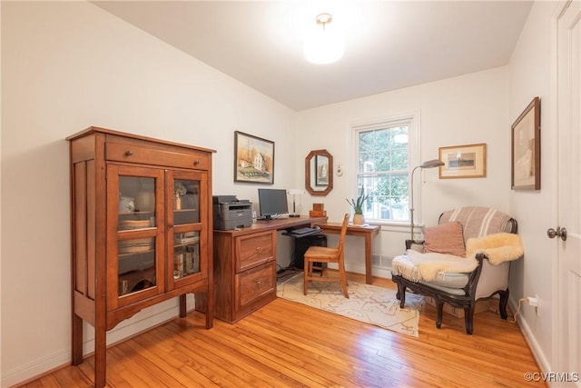 home office featuring light wood-type flooring and baseboards