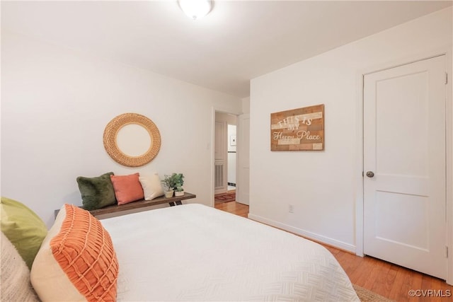 bedroom featuring light wood-type flooring and baseboards
