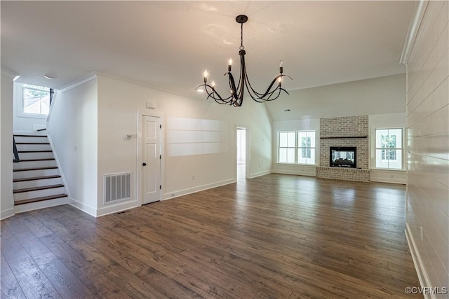 15148 Johns Trace Cir, Montpelier, VA 23192 - unfurnished living room with dark wood-type flooring, a chandelier, stairway, plenty of natural light, and crown molding