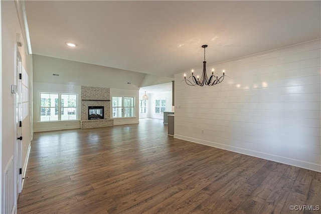 15148 Johns Trace Cir, Montpelier, VA 23192 - unfurnished living room with a chandelier, dark wood-style floors, baseboards, a fireplace, and recessed lighting