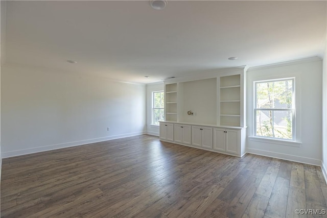 15148 Johns Trace Cir, Montpelier, VA 23192 - empty room featuring baseboards, dark wood-type flooring, crown molding, and built in features