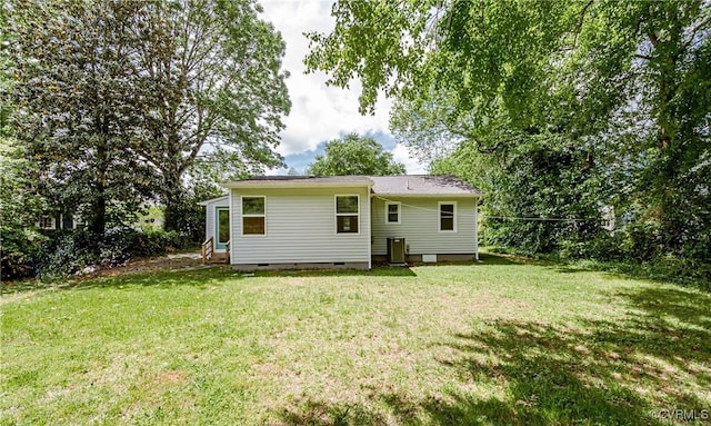 rear view of house featuring crawl space and a yard