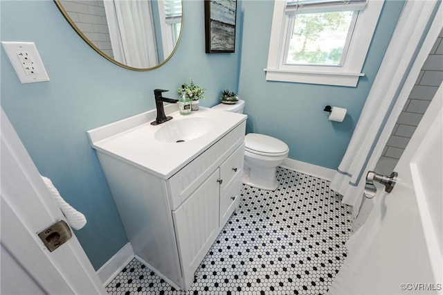 full bathroom with vanity, toilet, baseboards, curtained shower, and tile patterned flooring