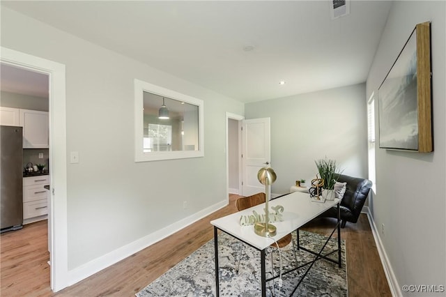 home office featuring light wood-style floors and baseboards