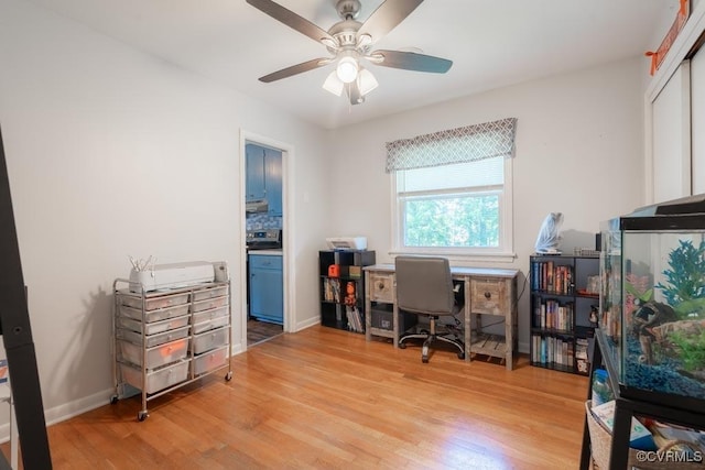 office with light wood finished floors, ceiling fan, and baseboards