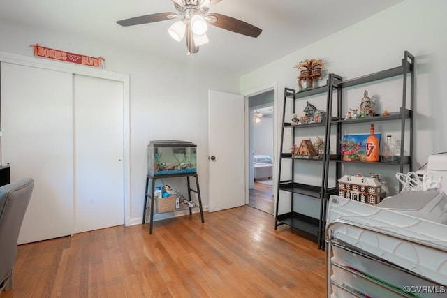bedroom featuring wood finished floors, a closet, and a ceiling fan