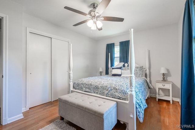 bedroom featuring wood finished floors, a closet, baseboards, and a ceiling fan