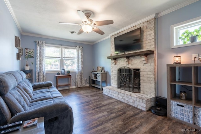 living room with a ceiling fan, dark wood-type flooring, a fireplace, ornamental molding, and baseboards