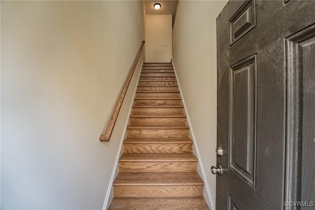 staircase featuring baseboards