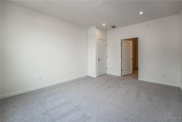 unfurnished bedroom featuring recessed lighting, carpet floors, and baseboards