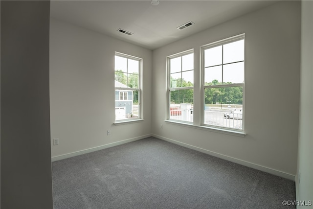 carpeted spare room with baseboards