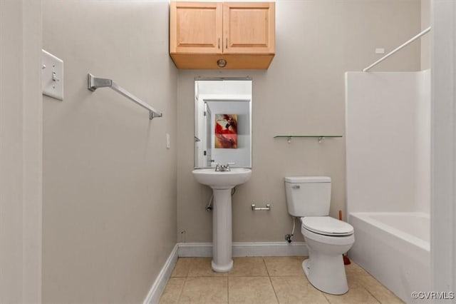 bathroom with toilet, tile patterned flooring, baseboards, bathtub / shower combination, and a sink