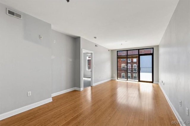 unfurnished room featuring light wood-type flooring and baseboards